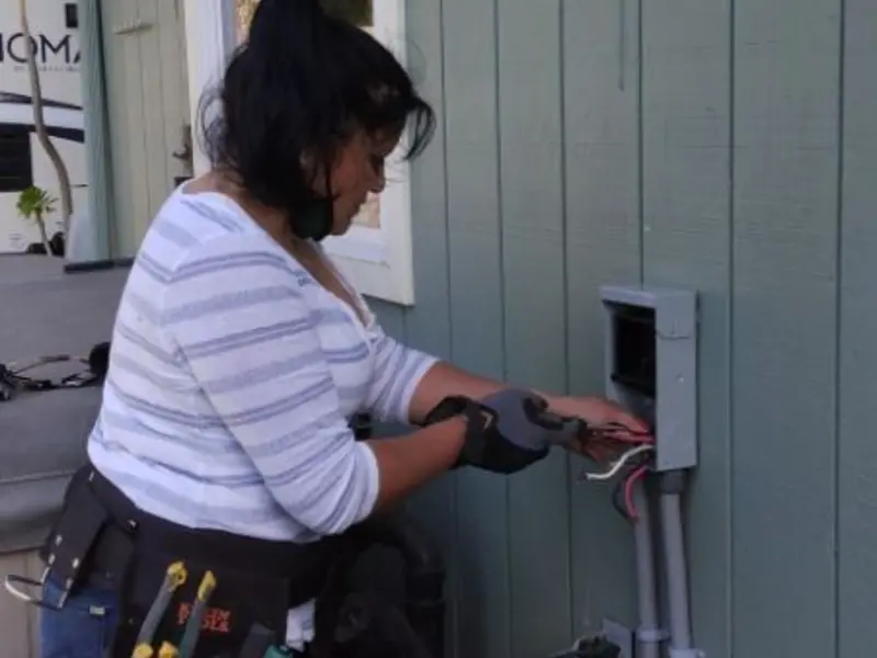 Licensed electrician wiring an exterior subpanel in Downers Grove